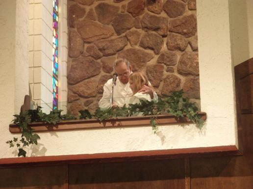 Ted Bartell baptizes his granddaughter, Emily